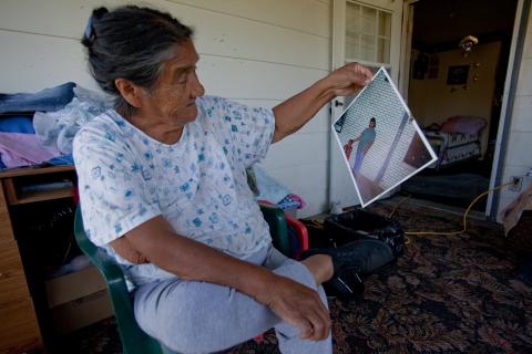 Ruby Stump looks at a photograph retrieved from her flooded basement.